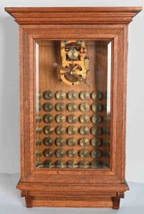 A Gamewell Excelsior fire alarm transmitter with 50 code wheels, in a refinished oak case with beveled-glass front door, sold for $7,800 at a sale of the Brian Maiher collection of railroadiana, petroliana, and antique fire alarms held August 29 by Milestone Auctions in Willoughby, OH