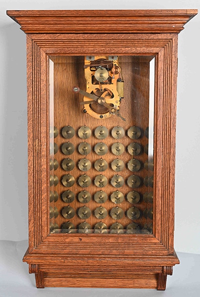 A Gamewell Excelsior fire alarm transmitter with 50 code wheels, in a refinished oak case with beveled-glass front door, sold for $7,800 at a sale of the Brian Maiher collection of railroadiana, petroliana, and antique fire alarms held August 29 by Milestone Auctions in Willoughby, OH