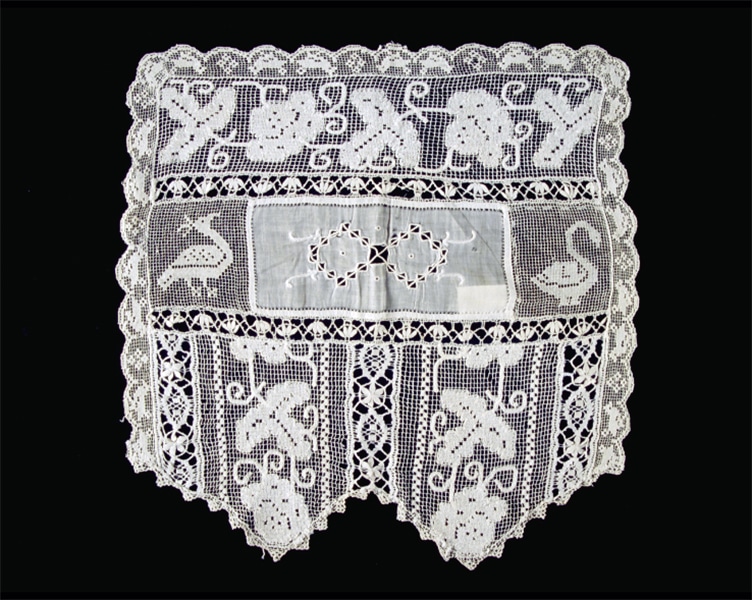 Single example from one of two pairs of lace chair arm covers. Rectangular with lightly scalloped side and back edges and larger scalloped front edge. Inner rectangle with foliate decoration. Original to Castle Tucker (Wiscasset, ME). photo: Historic New England