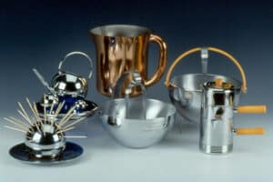 Modern serving ware designs for Chase, by Russel Wright. Clockwise from left: Cocktail Ball on Olympia Saucer; Pancake & Corn Set; Devonshire Pitcher; Antarctic Ice Bowl; Individual Coffee Set; Ice Bowl & Tongs.