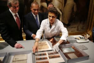 Museum of Fine Arts Boston Head of Objects Conservation Pam Hatchfield, right, displays objects removed a time capsule, Jan. 6, 2015, as Mass. Secretary of State William Galvin, left, and Mass. Gov. Deval Patrick, second from left, look on at the museum, in Boston.
